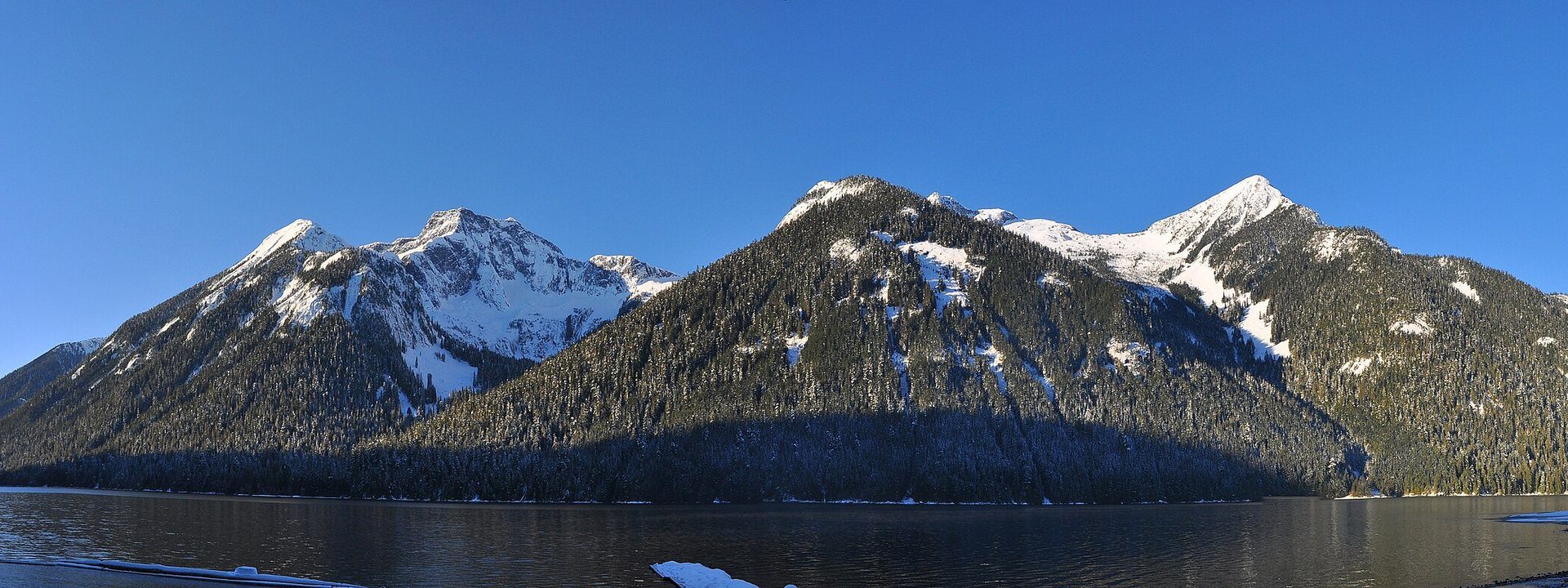 Chilliwack Lake on a clear winter day, snow on the peaks above calm water